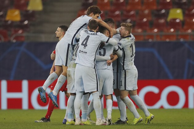 Chelsea's Olivier Giroud celebrates with his teammates after scoring his side's first goal during the Champions League, round of 16, first leg soccer match between Atletico Madrid and Chelsea at the National Arena stadium in Bucharest, Romania, Tuesday, Feb. 23, 2021. (AP Photo/Vadim Ghirda)