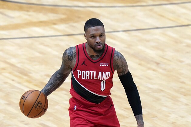 Portland Trail Blazers guard Damian Lillard (0) moves the ball up court in the first half of an NBA basketball game against the New Orleans Pelicans in New Orleans, Wednesday, Feb. 17, 2021. (AP Photo/Gerald Herbert)