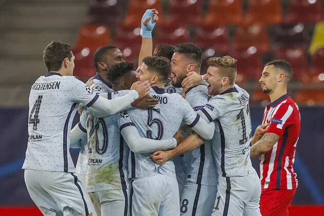 Chelsea's Olivier Giroud celebrates with his teammates after scoring his side's first goal during the Champions League, round of 16, first leg soccer match between Atletico Madrid and Chelsea at the National Arena stadium in Bucharest, Romania, Tuesday, Feb. 23, 2021. (AP Photo/Vadim Ghirda)