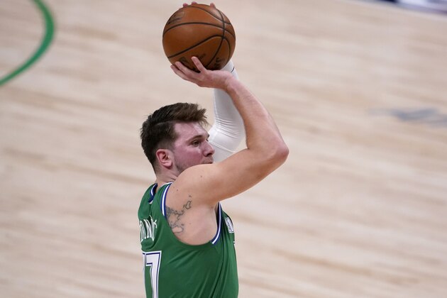 Dallas Mavericks' Luka Doncic shoots and sinks a three-point basket in the second half of an NBA basketball game against the Memphis Grizzlies in Dallas, Monday, Feb. 22, 2021. (AP Photo/Tony Gutierrez)