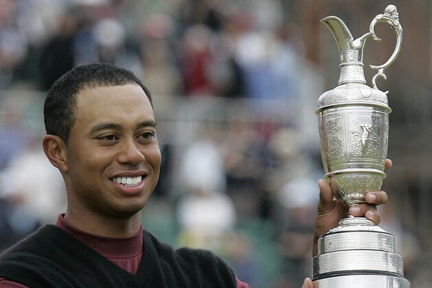 Tiger Woods displays the trophy after winning the British Open Golf Championship, on the Old Course at St. Andrews Scotland, Sunday July 17 , 2005.    Woods  finished the championship at 14-under-par to win the trophy.  (AP Photo/Ted S. Warren)