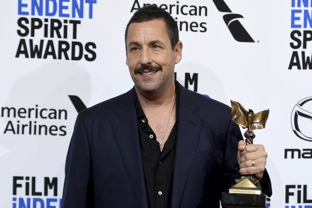 Adam Sandler poses in the press room with the award for best male lead for