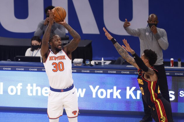 New York Knicks' Julius Randle (30) shoots against Atlanta Hawks' John Collins (20) during the first quarter of an NBA basketball game Monday, Feb. 15, 2021, in New York. (AP Photo/Jason DeCrow, Pool)