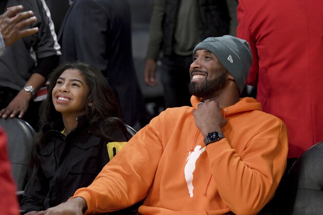 Former Los Angeles Laker Kobe Bryant and his daughter Gianna Bryant attend an NBA basketball game between the Los Angeles Lakers and Dallas Mavericks Sunday, Dec. 29, 2019, in Los Angeles. (AP Photo/Michael Owen Baker)