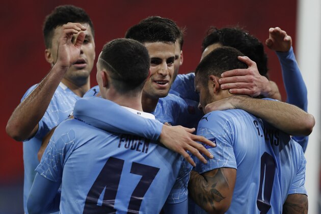 Manchester City's Gabriel Jesus, right, celebrates after scoring his side's second goal during the Champions League round of 16 first leg soccer match between Borussia Monchengladbach and Manchester City at the Puskas Arena stadium in Budapest, Hungary, Wednesday, Feb. 24, 2021. (AP Photo/Laszlo Balogh)