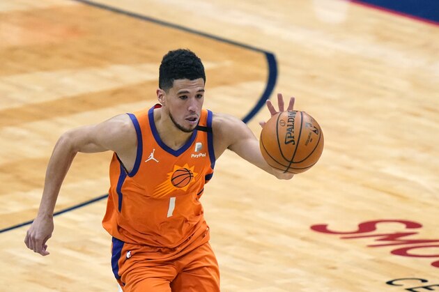 Phoenix Suns guard Devin Booker (1) breaks down court in the second half of an NBA basketball game against the New Orleans Pelicans in New Orleans, Friday, Feb. 19, 2021. (AP Photo/Gerald Herbert)