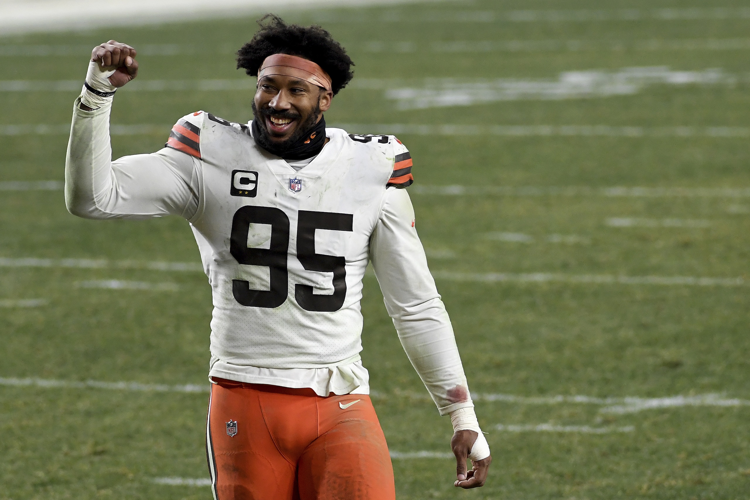 Cleveland Browns defensive end Myles Garrett (95) smiles as he walks off the field after defeating the Pittsburgh Steelers 48-37 during an NFL wild-card playoff football game, Sunday, Jan. 10, 2021, in Pittsburgh. (AP Photo/Justin Berl)