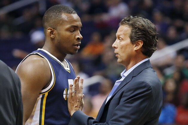 Utah Jazz head coach Quin Snyder, right, talks with Elijah Millsap during the first half of an NBA preseason basketball game against the Phoenix Suns, Friday, Oct. 9, 2015, in Phoenix. (AP Photo/Ross D. Franklin)
