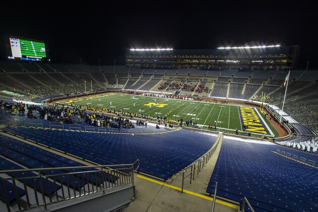 A small number of athletes' invited guests from Michigan and Wisconsin watch in an otherwise empty Michigan Stadium at the kickoff of an NCAA college football game in Ann Arbor, Mich., Saturday, Nov. 14, 2020. (AP Photo/Tony Ding)