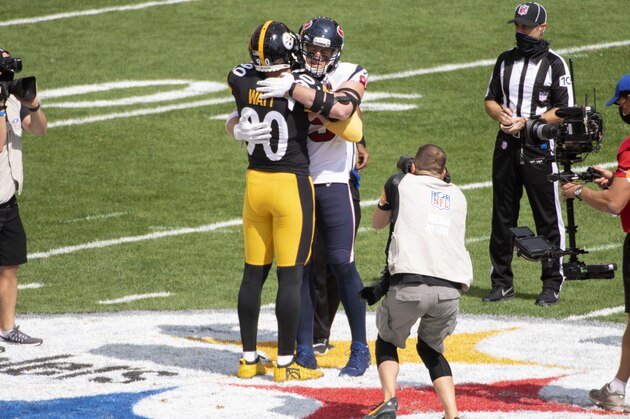 Pittsburgh Steelers outside linebacker T.J. Watt (90) hugs his brother Houston Texans defensive end J.J. Watt (99) as they participate in the coin toss during an NFL football game, Sunday, Sept. 27, 2020, in Pittsburgh. (AP Photo/Justin Berl)