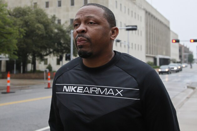 FILE - In this Sept. 27, 2017, file photo, Lamont Evans, an assistant basketball coach at Oklahoma State University, leaves the federal courthouse following a court appearance in Oklahoma City. Evans is scheduled to appear in a New York City courtroom on Thursday, Oct. 12, for his part in a case in which coaches and others are charged with using hundreds of thousands of dollars in bribes to influence the choices star athletes make about schools, sponsors, agents and financial advisers. (AP Photo/Sue Ogrocki, File)