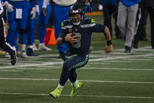 Seattle Seahawks quarterback Russell Wilson runs with the ball during the second half of an NFL wild-card playoff football game against the Los Angeles Rams, Saturday, Jan. 9, 2021, in Seattle. The Rams won 30-20. (AP Photo/Stephen Brashear)