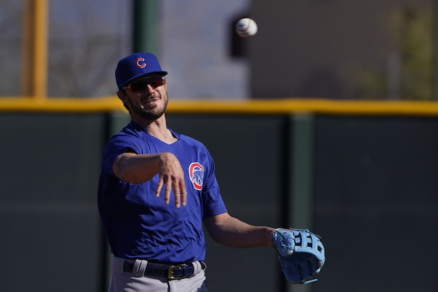 Chicago Cubs' Kris Bryant throws the ball during the team's spring training baseball workout in Mesa, Ariz., Monday, Feb. 22, 2021. (AP Photo/Jae C. Hong)