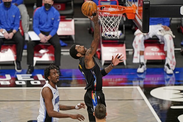 Orlando Magic forward Al-Farouq Aminu (2) watches as Brooklyn Nets guard Kyrie Irving (11) goes to the basket during the first quarter of an NBA basketball game, Thursday, Feb. 25, 2021, in New York. (AP Photo/Kathy Willens)