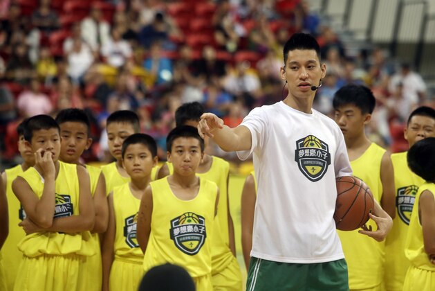 Former Toronto Raptors' Jeremy Lin, currently a free agent, talks to young Taiwanese players during a basketball clinic in Taipei, Taiwan, Saturday, July 27, 2019. Lin is in Taiwan to attend a charity event and basketball clinics for young athletes. (AP Photo/Chiang Ying-ying)