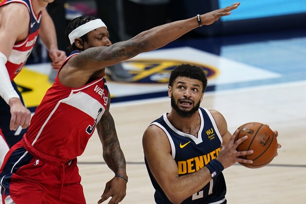 Denver Nuggets guard Jamal Murray (27) is pressured by Washington Wizards guard Bradley Beal (3) during the second quarter of an NBA basketball game Thursday, Feb. 25, 2021, in Denver. (AP Photo/Jack Dempsey)