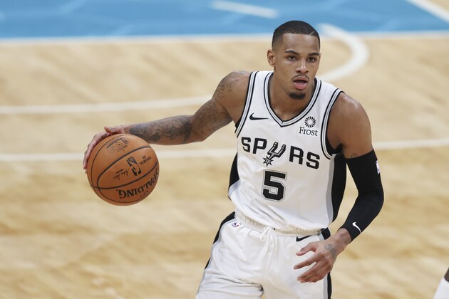 San Antonio Spurs guard Dejounte Murray brings the ball up court against the Charlotte Hornets during the second half of an NBA basketball game in Charlotte, N.C., Sunday, Feb. 14, 2021. San Antonio won 122-110. (AP Photo/Nell Redmond)