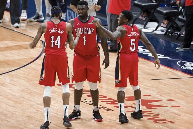 New Orleans Pelicans forward Zion Williamson (1) celebrates with forward Brandon Ingram (14) and guard Eric Bledsoe (5) following the team's win over the Memphis Grizzlies in an NBA basketball game in New Orleans, Saturday, Feb. 6, 2021. (AP Photo/Derick Hingle)