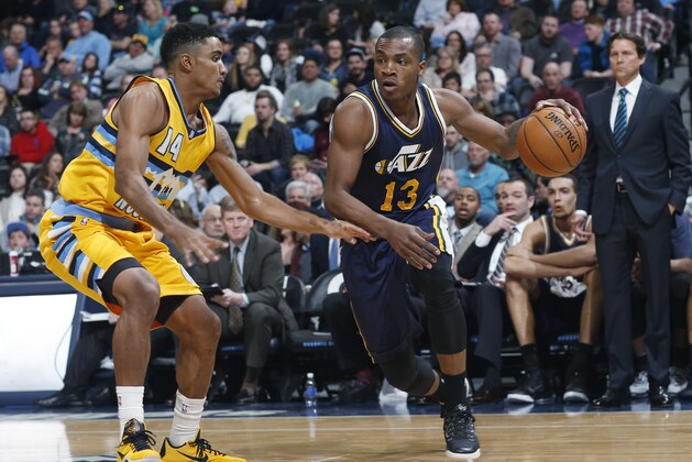 Utah Jazz guard Elijah Millsap, right, drives as Denver Nuggets guard Gary Harris defends during the fourth quarter of an NBA basketball game Friday, Feb. 27, 2015, in Denver. Utah won 104-82. (AP Photo/David Zalubowski)