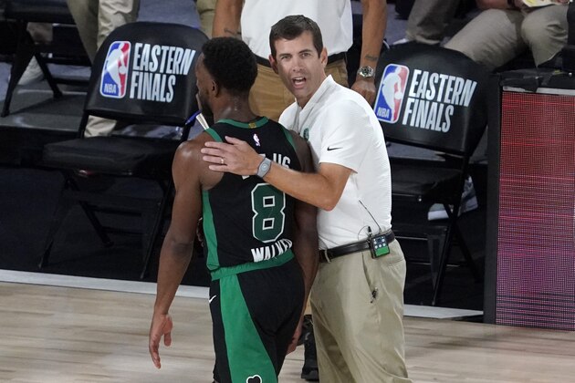 Boston Celtics' Kemba Walker (8) walks to the bench during a time out as head coach Brad Stevens congratulates him on sinking a basket late in overtime of an NBA conference final playoff basketball game against the Miami Heat on Tuesday, Sept. 15, 2020, in Lake Buena Vista, Fla. (AP Photo/Mark J. Terrill) Boston Celtics' Kemba Walker (8) walks to the bench during a time out as head coach Brad Stevens congratulates him on sinking a basket late in overtime of an NBA conference final playoff basketball game against the Miami Heat on Tuesday, Sept. 15, 2020, in Lake Buena Vista, Fla. (AP Photo/Mark J. Terrill)