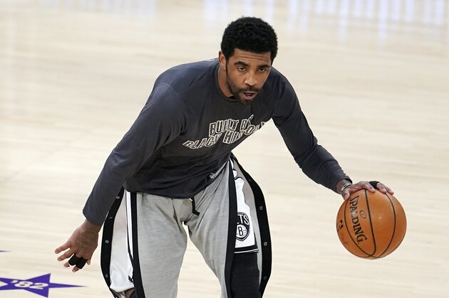 Brooklyn Nets guard Kyrie Irving warms up before an NBA basketball game against the Los Angeles Lakers Thursday, Feb. 18, 2021, in Los Angeles. (AP Photo/Marcio Jose Sanchez)