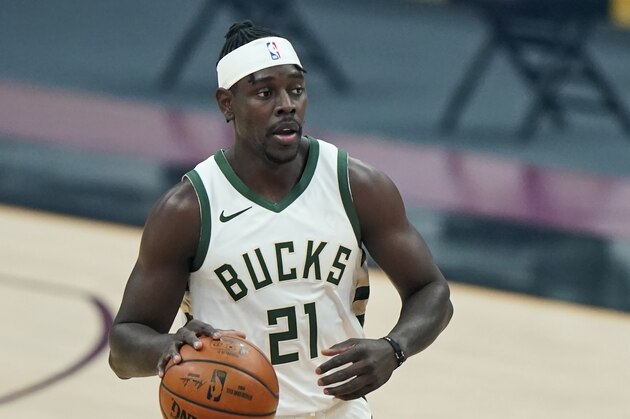 Milwaukee Bucks' Jrue Holiday drives in the first half of an NBA basketball game against the Cleveland Cavaliers, Friday, Feb. 5, 2021, in Cleveland. (AP Photo/Tony Dejak)