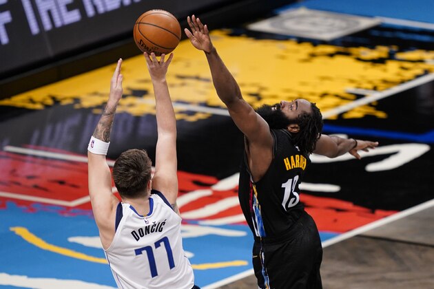 Dallas Mavericks guard Luka Doncic (77) shoots against Brooklyn Nets guard James Harden (13) during the second half of an NBA basketball game, Saturday, Feb. 27, 2021, in New York. (AP Photo/John Minchillo)