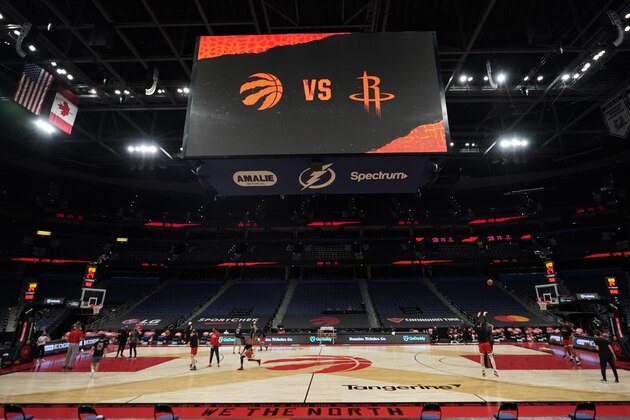 Some members of the Toronto Raptors and Houston Rockets take part in a shoot around before an NBA basketball game Friday, Feb. 26, 2021, in Tampa, Fla. Five members of the Raptors' coaching staff, including head coach Nick Nurse, are missing the game due to coronavirus protocols. (AP Photo/Chris O'Meara)