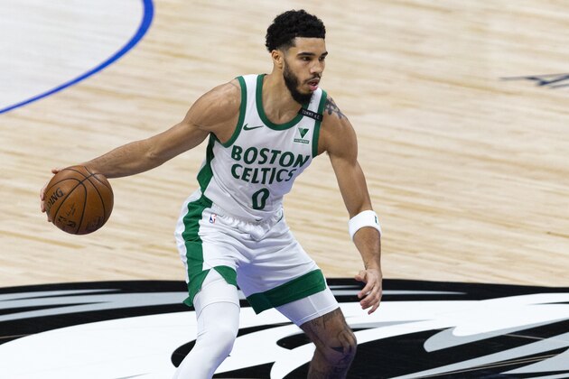 Boston Celtics forward Jayson Tatum (0) handles the ball during the first half of an NBA basketball game against the Dallas Mavericks in Dallas, Tuesday, Feb. 23, 2021. (AP Photo/Sam Hodde)