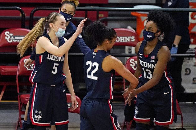 Connecticut's Paige Bueckers (5), Evina Westbrook (22) and Christyn Williams (13) celebrate during the fourth quarter of the team's NCAA college basketball game against St. John's, Wednesday, Feb. 17, 2021, in New York.(AP Photo/Kathy Willens)
