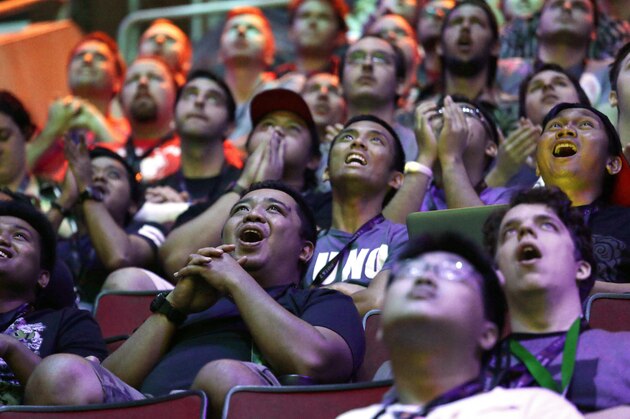 Fans cheer during the International Dota 2 Championships at KeyArena Wednesday, Aug. 9, 2017, in Seattle. Members of the five-person eSport teams each select fantasy-world hero characters and the teams then face off for control of the game world's map. The championship, pitting 16 teams against each other for $24 million in prize money, runs through Saturday. (AP Photo/Elaine Thompson)