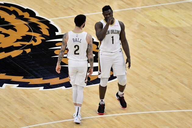 New Orleans Pelicans forward Zion Williamson (1) and guard Lonzo Ball (2) talk on the court in the first half of an NBA basketball game Tuesday, Feb. 16, 2021, in Memphis, Tenn. (AP Photo/Brandon Dill)