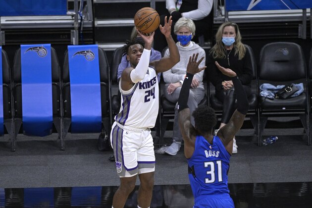 Sacramento Kings guard Buddy Hield (24) shoots in front of Orlando Magic guard Terrence Ross (31) during the first half of an NBA basketball game, Wednesday, Jan. 27, 2021, in Orlando, Fla. (AP Photo/Phelan M. Ebenhack)