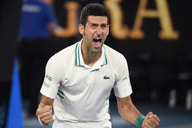Serbia's Novak Djokovic celebrates after defeating Russia's Daniil Medvedev in the men's singles final at the Australian Open tennis championship in Melbourne, Australia, Sunday, Feb. 21, 2021.(AP Photo/Andy Brownbill)