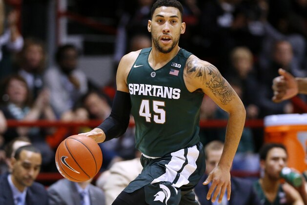 FILE - In this Dec. 19, 2015, file photo, Michigan State's Denzel Valentine brings the ball upcourt during an NCAA college basketball game against Northeastern in Boston.  Valentine worked out for the Utah Jazz just under two weeks ago and that was the first of four scheduled workouts, along with the Bulls, Bucks and Magic. The Michigan State guard explained that his agent had identified the Jazz as a potential landing spot. He’s expected to go anywhere from late lottery to the late 20s. (AP Photo/Winslow Townson, File)