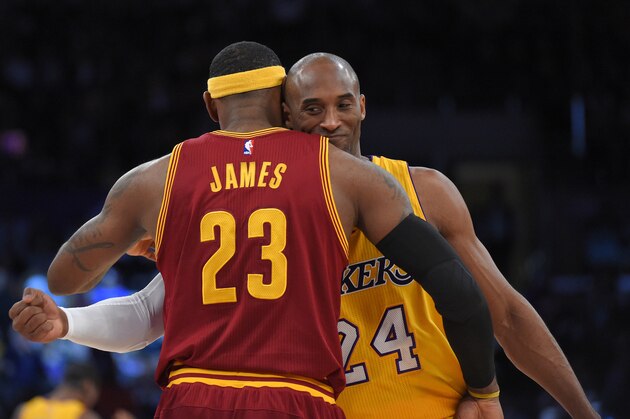 Cleveland Cavaliers forward LeBron James, left, and Los Angeles Lakers guard Kobe Bryant hug prior to an NBA basketball game, Thursday, Jan. 15, 2015, in Los Angeles. (AP Photo/Mark J. Terrill)