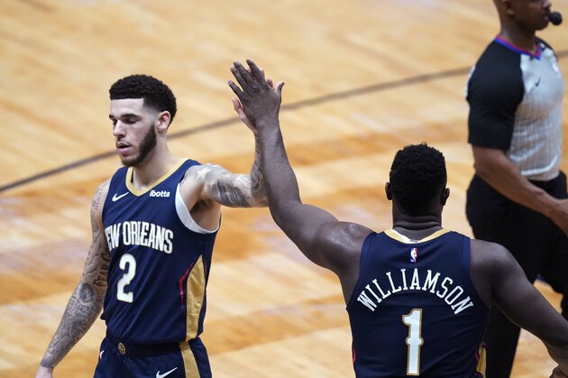 New Orleans Pelicans forward Zion Williamson (1) celebrates with guard Lonzo Ball (2) during the second half of the team's NBA basketball game against the Detroit Pistons in New Orleans, Wednesday, Feb. 24, 2021. The Pelicans won 128-118. (AP Photo/Gerald Herbert)