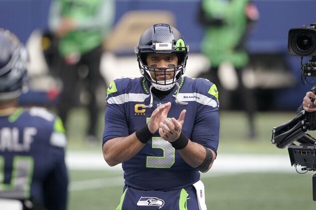 Seattle Seahawks quarterback Russell Wilson begins to warm-up before an NFL wild-card playoff football game against the Los Angeles Rams, Saturday, Jan. 9, 2021, in Seattle. (AP Photo/Ted S. Warren)