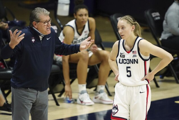 Connecticut head coach Geno Auriemma, left, talks with guard Paige Bueckers (5) during a break in the first quarter against Marquette during an NCAA college basketball game Monday, March 1, 2021, in Storrs, Conn. (David Butler II/Pool Photo via AP)