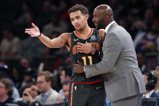 Atlanta Hawks coach Lloyd Pierce talks to guard Trae Young (11) on the sideline during the first half of the team's preseason NBA basketball game against the New York Knicks in New York, Wednesday, Oct. 16, 2019. (AP Photo/Kathy Willens)