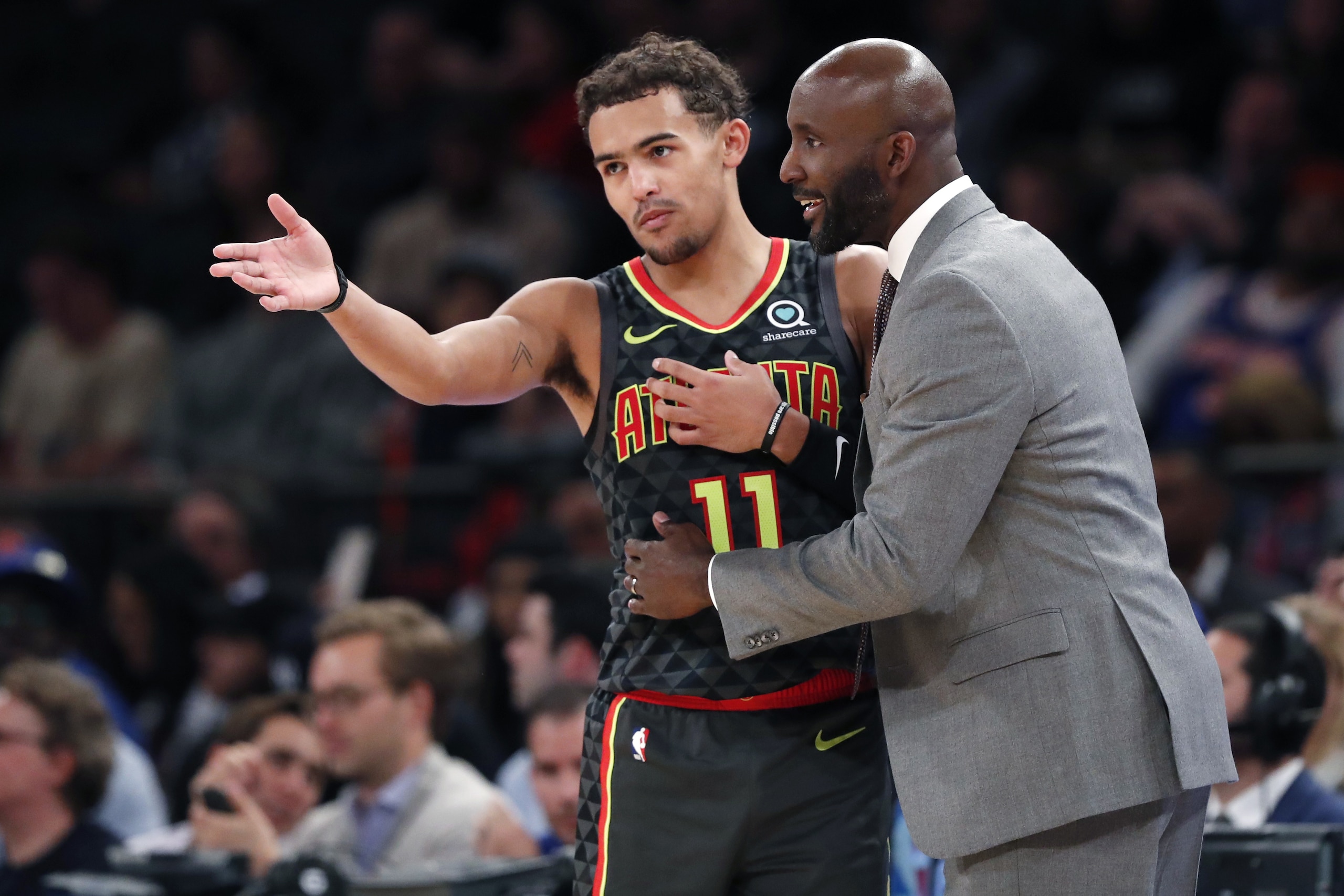 Atlanta Hawks coach Lloyd Pierce talks to guard Trae Young (11) on the sideline during the first half of the team's preseason NBA basketball game against the New York Knicks in New York, Wednesday, Oct. 16, 2019. (AP Photo/Kathy Willens)