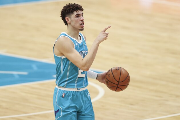 Charlotte Hornets guard LaMelo Ball directs the offense against the Minnesota Timberwolves during the second half of an NBA basketball game in Charlotte, N.C., Friday, Feb. 12, 2021. Charlotte won 120-114. (AP Photo/Nell Redmond)