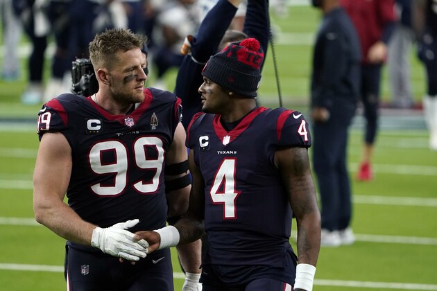 Houston Texans defensive end J.J. Watt (99) and quarterback Deshaun Watson (4) walk off the field after an NFL football game against the Tennessee Titans Sunday, Jan. 3, 2021, in Houston. The Titans won 41-38. (AP Photo/Eric Christian Smith)