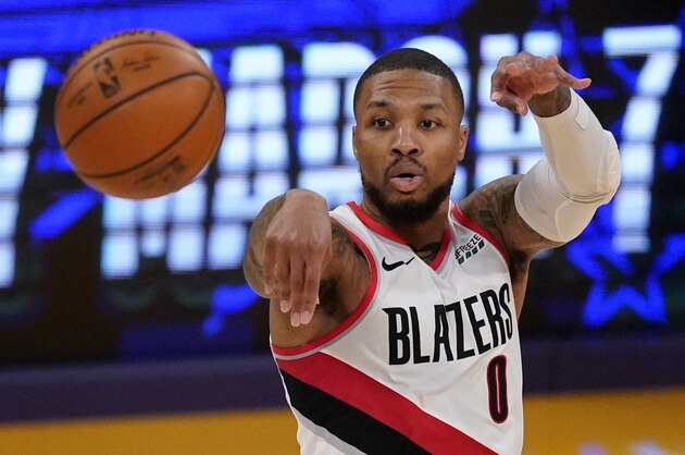 Portland Trail Blazers guard Damian Lillard passes the ball during the second half of an NBA basketball game against the Los Angeles Lakers Friday, Feb. 26, 2021, in Los Angeles. The Lakers won 102-93. (AP Photo/Mark J. Terrill)