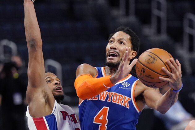 New York Knicks guard Derrick Rose (4) attempts a layup as Detroit Pistons guard Dennis Smith Jr. (0) defends during the first half of an NBA basketball game, Sunday, Feb. 28, 2021, in Detroit. (AP Photo/Carlos Osorio)