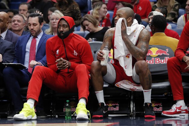 Houston Rockets guard James Harden, left, sits next on the bench next to forward PJ Tucker in the second half of an NBA basketball game against the New Orleans Pelicans in New Orleans, Sunday, Dec. 29, 2019. The Pelicans won 127-112. (AP Photo/Gerald Herbert)