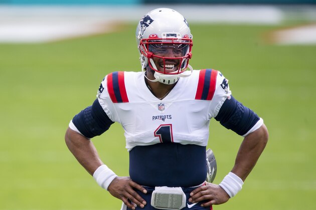 New England Patriots quarterback Cam Newton (1) smiles on the field before the Patriots take on the Miami Dolphins during an NFL football game, Sunday, Dec. 20, 2020, in Miami Gardens, Fla. (AP Photo/Doug Murray)