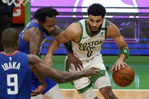 Boston Celtics forward Jayson Tatum (0) drives against Los Angeles Clippers guard Patrick Beverley, left, and center Serge Ibaka (9) in the third quarter of an NBA basketball game, Tuesday, March 2, 2021, in Boston. (AP Photo/Elise Amendola)