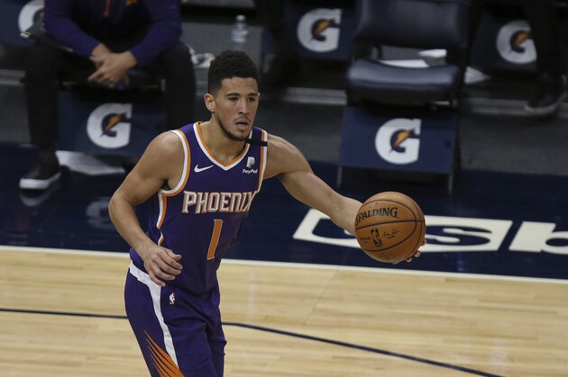 Phoenix Suns' Devin Booker (1) handles the ball in the first half of an NBA basketball game against the Minnesota Timberwolves, Sunday, Feb. 28, 2021, in Minneapolis. (AP Photo/Stacy Bengs)