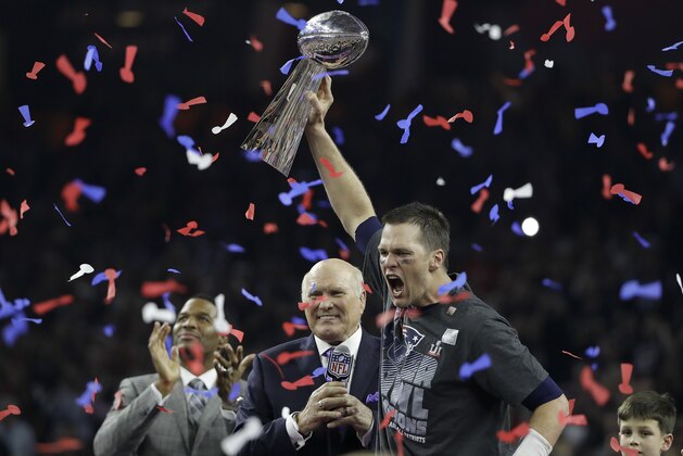 New England Patriots' Tom Brady, right, celebrates with the Vince Lombardi Trophy next to broadcasters Terry Bradshaw, center, and Michael Strahan after the NFL Super Bowl 51 football game against the Atlanta Falcons Sunday, Feb. 5, 2017, in Houston. (AP Photo/Elise Amendola)